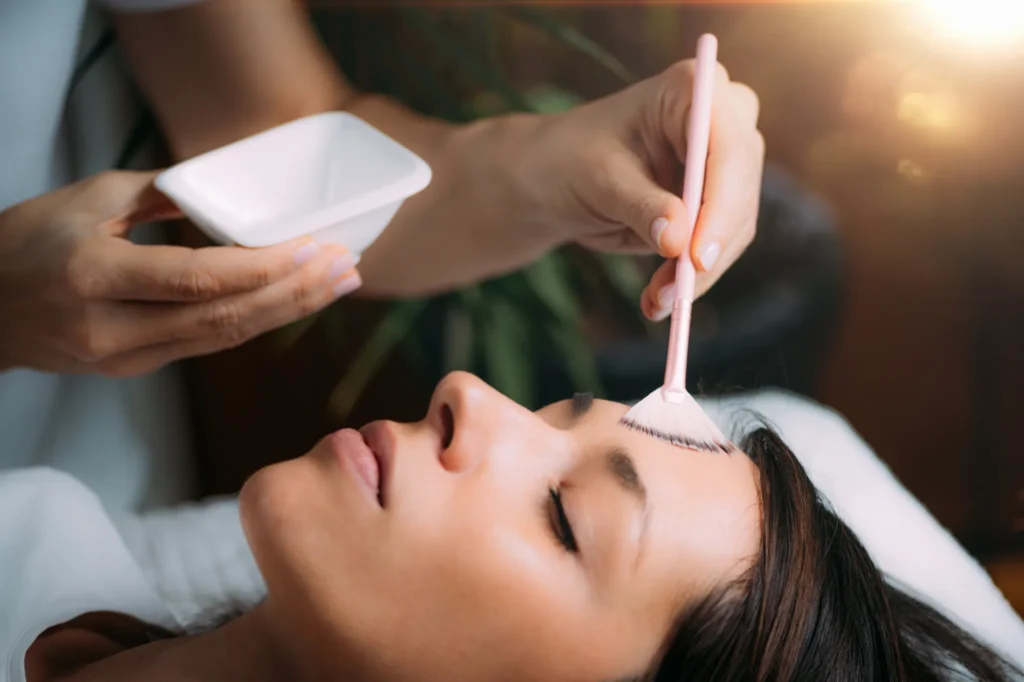“Skin care professional performing a chemical peel procedure.”